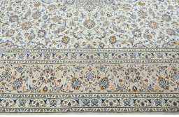 Corner detail of 2000s Kashan rug showing border pattern and Wool pile