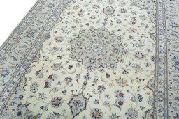 Backside of handmade 2000s Kashan rug showing knot structure and weave density
