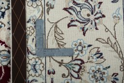 Backside of handmade New Nain rug showing knot structure and weave density