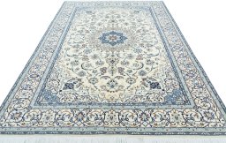 Surface texture of 2000s Nain rug with natural Wool and intricate pattern