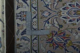 Backside of handmade 2000s Kashan rug showing knot structure and weave density