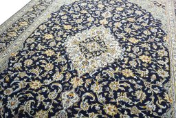 Backside of handmade 2000s Kashan rug showing knot structure and weave density