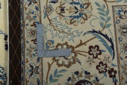 Backside of handmade 2000s Nain rug showing knot structure and weave density
