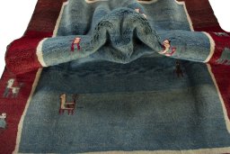 Corner detail of 2000s Persian Gabbeh rug showing border pattern and Wool pile