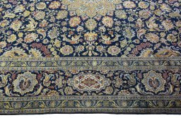 Corner detail of 2000s Kashan rug showing border pattern and Wool pile
