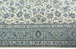Corner detail of 2000s Kashan rug showing border pattern and Wool pile