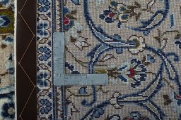Backside of handmade 2000s Kashan rug showing knot structure and weave density