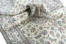 Surface texture of 2000s Nain rug with natural Wool and intricate pattern