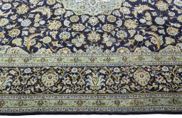 Corner detail of 2000s Kashan rug showing border pattern and Wool pile
