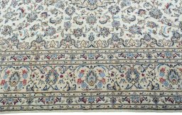 Corner detail of 2000s Kashan rug showing border pattern and Wool pile