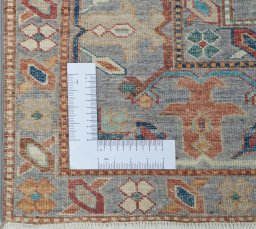 Corner detail of New Kazak rug showing border pattern and Wool pile