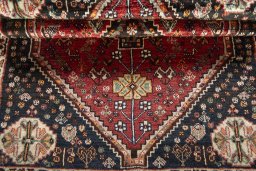 Corner detail of 2000s Shiraz rug showing border pattern and Wool pile