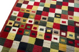 Backside of handmade 2000s Persian Gabbeh rug showing knot structure and weave density
