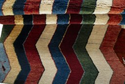 Full view of 2000s Persian Gabbeh rug from Pakistan, 163 × 105 cm in Multi Color tones
