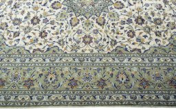 Corner detail of 2000s Kashan rug showing border pattern and Wool pile