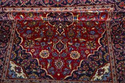 Corner detail of 2000s Kashan rug showing border pattern and Wool pile