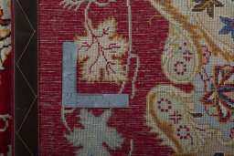 Backside of handmade 2000s Kashan rug showing knot structure and weave density