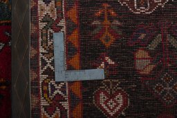 Surface texture of 2000s Shiraz rug with natural Wool and intricate pattern