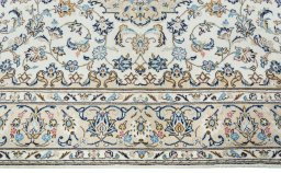Corner detail of New Kashan rug showing border pattern and Wool pile