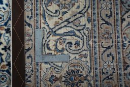 Backside of handmade 2000s Kashmar rug showing knot structure and weave density