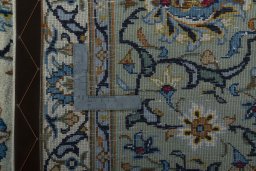 Backside of handmade 2000s Kashan rug showing knot structure and weave density