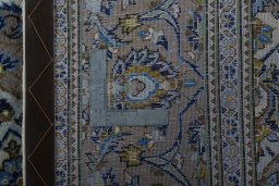 Backside of handmade 2000s Kashan rug showing knot structure and weave density
