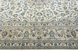 Corner detail of 2000s Kashan rug showing border pattern and Wool pile