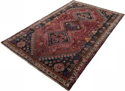 Corner detail of 2000s Shiraz rug showing border pattern and Wool pile