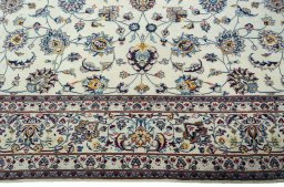 Corner detail of 2000s Mashad rug showing border pattern and Wool pile