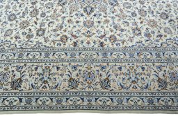 Corner detail of 2000s Kashan rug showing border pattern and Wool pile