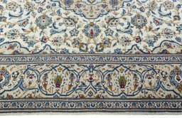 Corner detail of 2000s Kashan rug showing border pattern and Wool pile