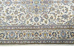 Corner detail of 2000s Kashan rug showing border pattern and Wool pile