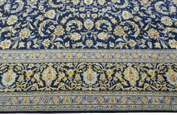 Corner detail of 2000s Kashan rug showing border pattern and Wool pile