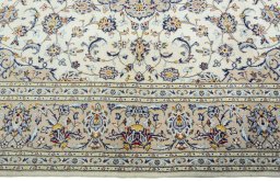 Corner detail of 2000s Kashan rug showing border pattern and Wool pile