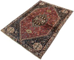 Corner detail of 2000s Shiraz rug showing border pattern and Wool pile