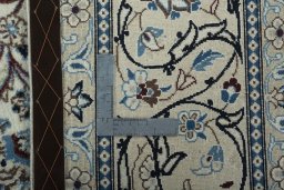 Backside of handmade 2000s Nain rug showing knot structure and weave density
