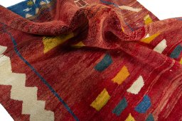 Corner detail of 2000s Persian Gabbeh rug showing border pattern and Wool pile