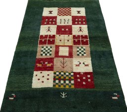 Surface texture of 2000s Persian Gabbeh rug with natural Wool and intricate pattern