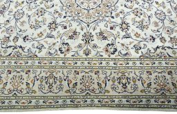 Corner detail of 2000s Kashan rug showing border pattern and Wool pile