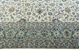 Corner detail of 2000s Kashan rug showing border pattern and Wool pile
