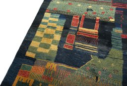 Backside of handmade 2000s Persian Gabbeh rug showing knot structure and weave density