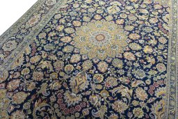 Backside of handmade 2000s Kashan rug showing knot structure and weave density
