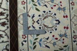 Backside of handmade 2000s Nain rug showing knot structure and weave density