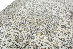 Backside of handmade 2000s Kashan rug showing knot structure and weave density