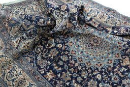Surface texture of 2000s Nain rug with natural Wool and intricate pattern