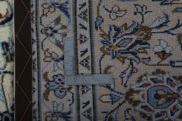 Backside of handmade 2000s Kashan rug showing knot structure and weave density