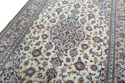 Backside of handmade 2000s Kashan rug showing knot structure and weave density