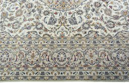 Corner detail of 2000s Kashan rug showing border pattern and Wool pile