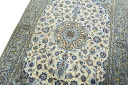 Backside of handmade 2000s Kashan rug showing knot structure and weave density