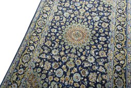 Backside of handmade 2000s Kashan rug showing knot structure and weave density
